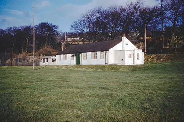 White building on green grass field.